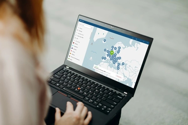 Woman activating a VPN on her laptop to hide her IP address and protect her privacy a blogger.