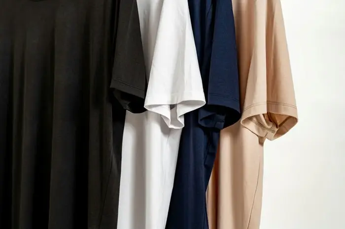 How to start a print on demand business step-by-step. Image shows four t-shirts hanging. 