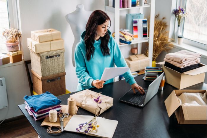 Why Sell Art Online in 2025? Woman prepares her recently sold packages of handmade products, since there has been a growing demand for personalized and handmade items, making this the perfect moment to connect with buyers who value authenticity.